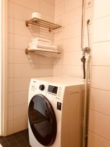 a washer and dryer in a laundry room at Antintorni Suite 17 in Pori