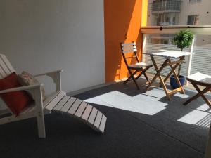 a balcony with chairs and a table and a table and chairs at Antintorni Suite 17 in Pori
