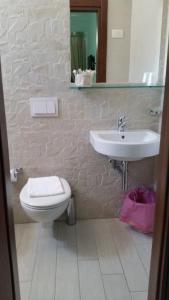 a bathroom with a sink and a toilet at Casa Barbara in Marzamemi