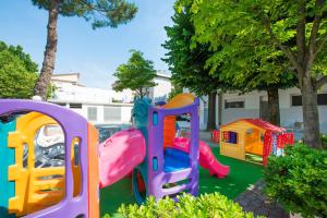 a playground with a play equipment in a yard at Hotel Bella Zurigo in Cesenatico