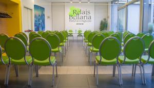 a conference room with green chairs and a table at Relais Bellaria Hotel & Congressi in Bologna