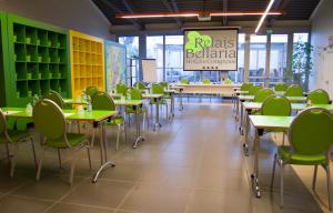 a classroom with tables and chairs in a cafeteria at Relais Bellaria Hotel & Congressi in Bologna