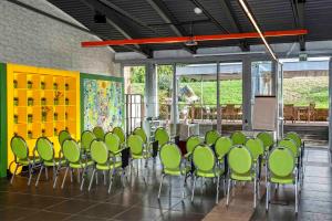 a room with a bunch of green chairs in it at Relais Bellaria Hotel & Congressi in Bologna