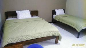 
Een bed of bedden in een kamer bij Cinnamon Guest House
