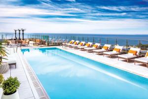 a beach with a lot of blue umbrellas at Hotel X Toronto by Library Hotel Collection in Toronto