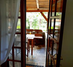 a view of a table and chairs from a window at Wood and Stone Villa in Sani Beach