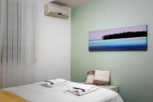 a room with two beds with towels on them at Terrazza a mare Corallo in Marina di Ragusa