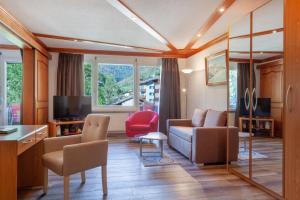 TV a/nebo společenská místnost v ubytování Hotel Beau Rivage