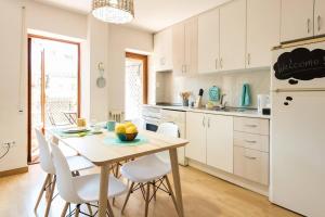 a kitchen with a wooden table and white appliances at Apartamento Caunedo in Madrid