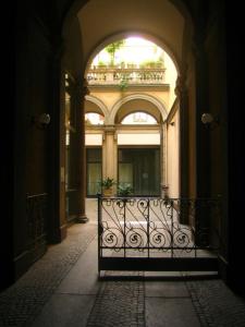 an entrance to a building with an iron gate at Castaldi house in Milan