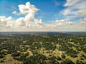 an aerial view of a city with trees and clouds at Sage Hill Inn & Spa in Kyle