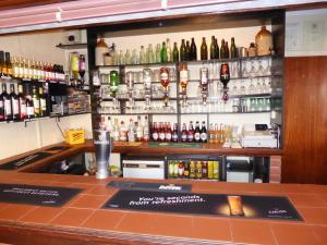 a bar with a lot of bottles of alcohol at The Denewood in Sandown