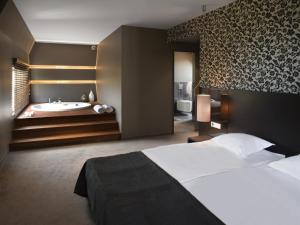 Postel nebo postele na pokoji v ubytování mOdus Hotel