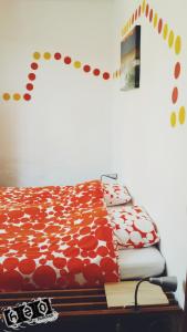 a bed with red and white pillows on a table at h2oholidays for you in Capbreton