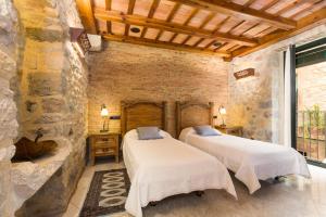 Postel nebo postele na pokoji v ubytování Hotel Històric