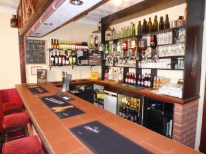 a bar with a lot of bottles of alcohol at The Denewood in Sandown
