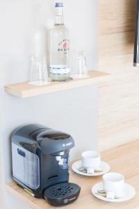 a bottle of water and a coffee maker on a shelf at Brüngers Landhaus in Rödinghausen