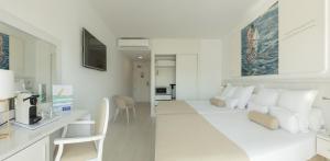 a white living room with a white couch and a table at Hotel Villa Luz in Gandía