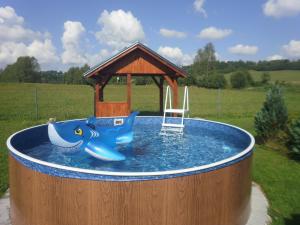 a small pool of water with a wooden gazebo at Apartman Hrabice in Vimperk