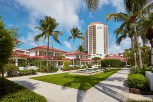 a view of the resort with palm trees and a building at Naples Grande Beach Resort in Naples