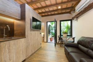 a living room with a couch and a table at Hotel Hist&ograve;ric in Girona