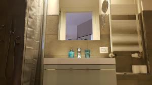 a bathroom with a sink and a mirror at Apartment Giotto Eremitani in Padova