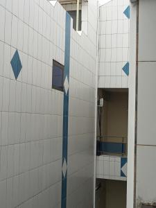 a building with blue and white tiles on it at Hotel FR Palace Tourbillon in Cotonou