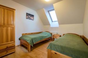 A bed or beds in a room at Guest House Privat Pod Lesom