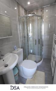 a bathroom with a shower and a toilet and a sink at Birmingham Central Station Apartment (Flat 2) in Birmingham