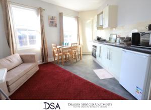 a living room with a couch and a kitchen at Birmingham Central Station Apartment (Flat 2) in Birmingham