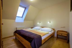 A bed or beds in a room at Guest House Privat Pod Lesom