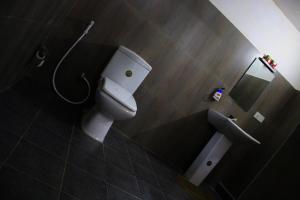 a bathroom with a toilet and a shower at Sigiriya Lahiru Homestay in Sigiriya