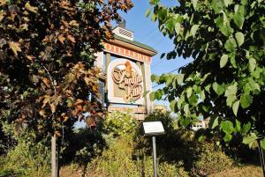 a sign in front of a building with a sign at Hotellerie Jardins de Ville in Sherbrooke