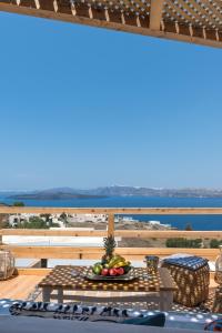 a table with a bowl of fruit on top of a balcony at Summer Lovers Villa in Akrotiri