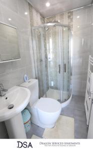 a bathroom with a shower and a toilet and a sink at Birmingham Central Station Apartment (Studio 3) in Birmingham