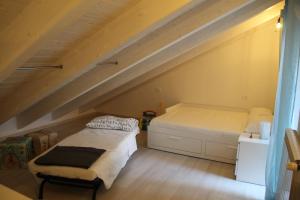 a bedroom with two beds in a attic at Il Piccolo Loft della Vela in Savona