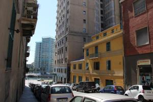 a city street with cars parked on the sides of buildings at Il Piccolo Loft della Vela in Savona