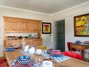 a kitchen with a wooden table with blue and white dishes on it at Le Petit Lievre in Aosta