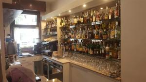 a bar with many bottles and glasses on the wall at Hotel Eternità in Malonno