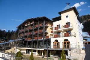 a large building with balconies on the side of it at Design Oberosler Hotel in Madonna di Campiglio