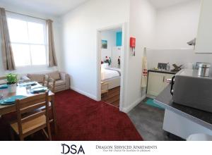a kitchen and a living room with a table and a bed at Birmingham Central Station Apartment (Flat 5) in Birmingham