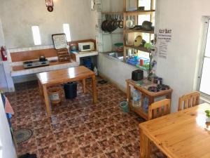 a kitchen with wooden tables and a counter at Bueng Pai Farm บึงปายฟาร์ม in Pai