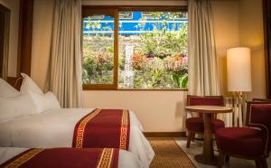 Cama ou camas em um quarto em Sumaq Machu Picchu Hotel