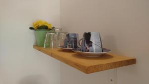 a wooden shelf with two bowls and a vase on it at Private room Andrea with private bathroom in Hvar