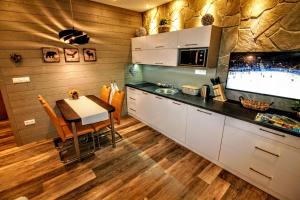 a kitchen with a table and a dining room at Prima Tatry in Starý Smokovec