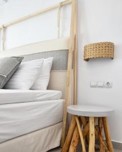 a bed and a stool next to a bunk bed at Angelos Boutique Suites in Patitiri