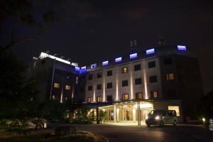 a building with a car parked in front of it at night at Smart Hotel Holiday in Mestre