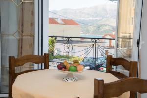 a bowl of fruit on a table on a balcony at Hellenic Sun in Lassi
