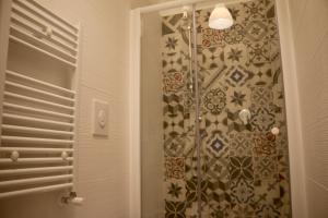a shower in a bathroom with a shower curtain at Villa Andrea in Bari +27 photos