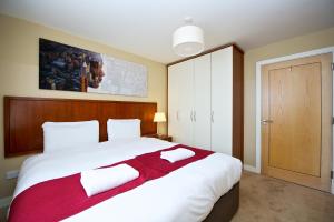 a hotel room with a bed and a dresser at Staycity Aparthotels Saint Augustine Street in Dublin